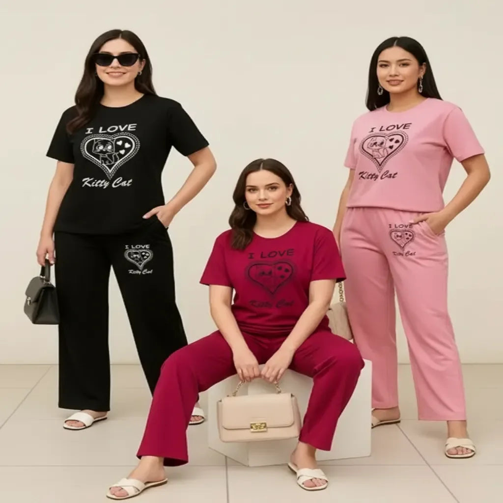 Four women wearing matching 'I Love Kitty Cat' outfits in black, pink, and red.