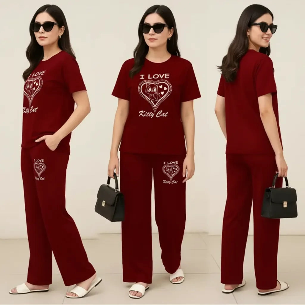 Woman wearing a red outfit with 'I Love Kitty Cat' text, holding a black handbag.