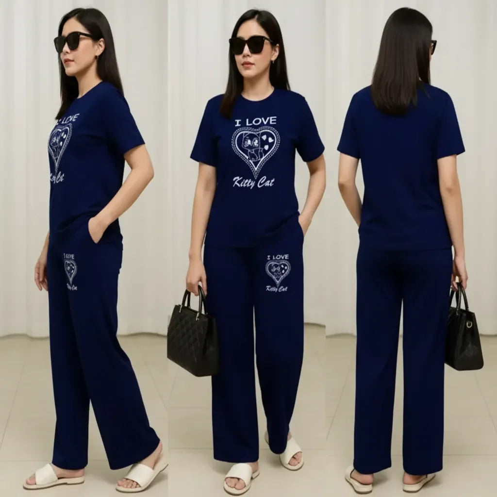 Woman wearing a navy blue outfit with 'I Love Kitty Cat' text, holding a black handbag.