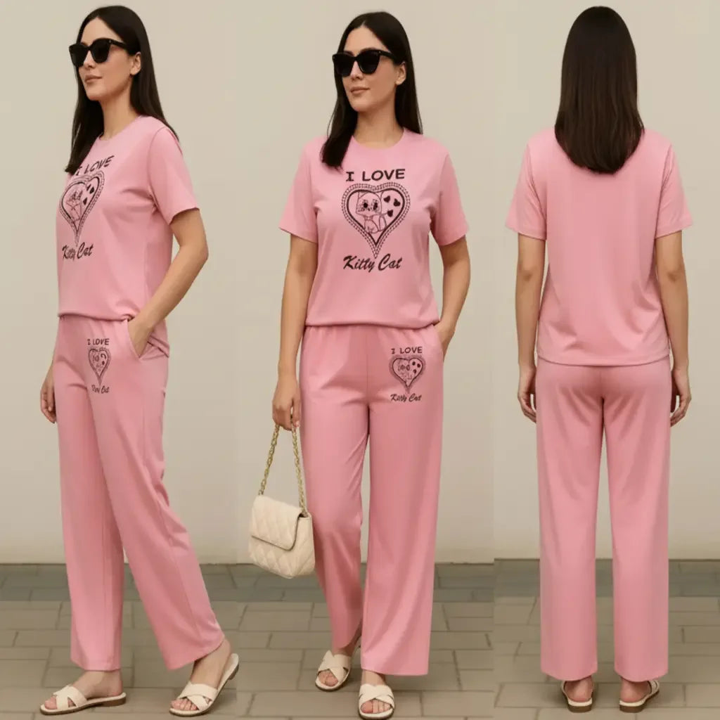 Woman wearing a pink outfit with 'I Love Kitty Cat' text, standing in front of a plain background.