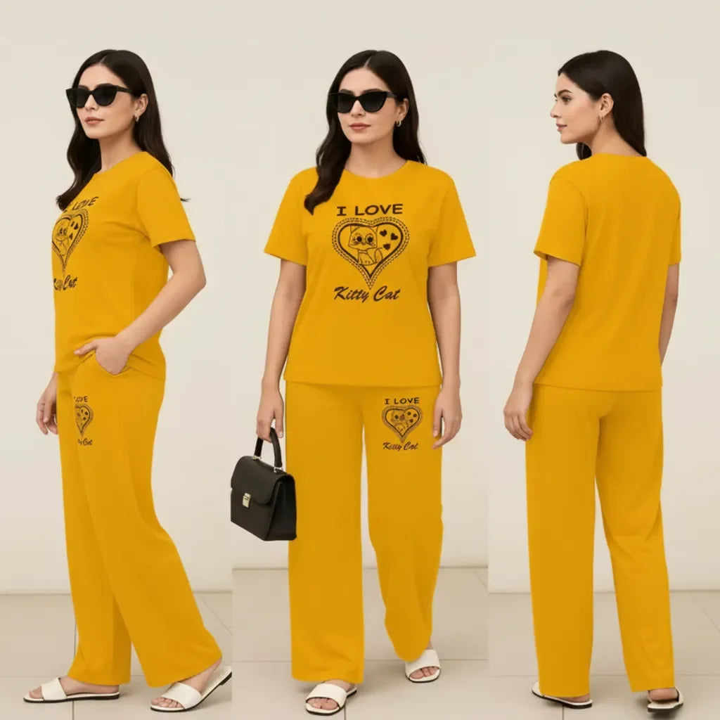 Woman wearing a yellow outfit with 'I Love Kitty Cat' text and heart design, holding a black handbag.